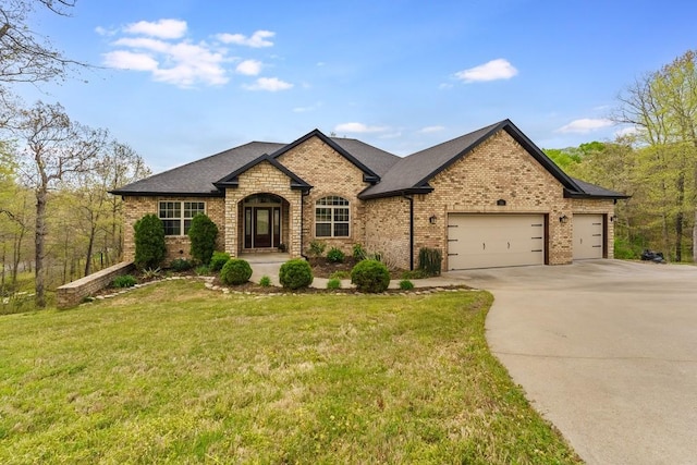 16 Carole Rae Ln, Bella Vista, AR 72714 - french provincial home featuring an attached garage, concrete driveway, brick siding, a front lawn, and a shingled roof