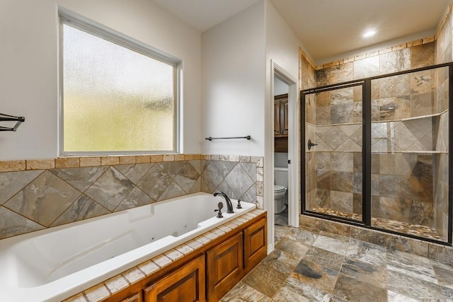 full bathroom featuring toilet, a whirlpool tub, a stall shower, and stone finish flooring