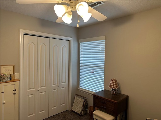 bedroom with a closet, visible vents, and a ceiling fan