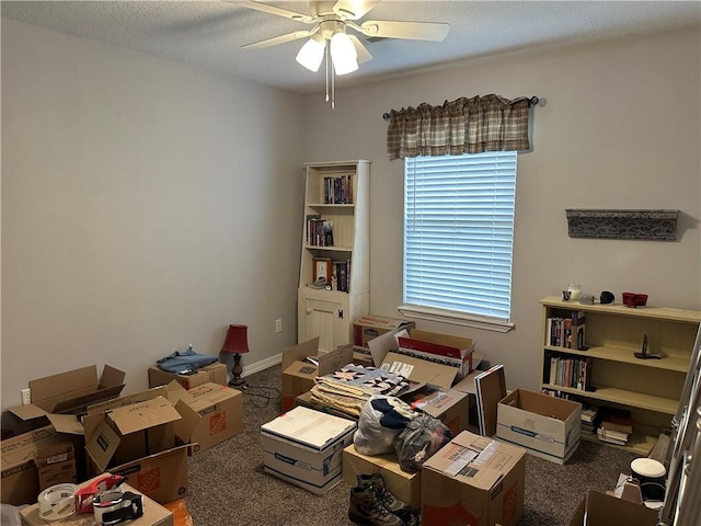 office area with carpet floors, a ceiling fan, and a textured ceiling