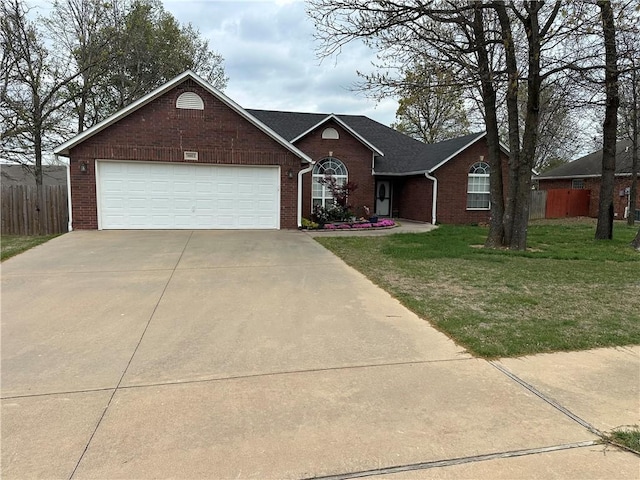 ranch-style home with fence, driveway, and brick siding