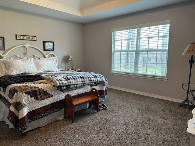 carpeted bedroom featuring baseboards