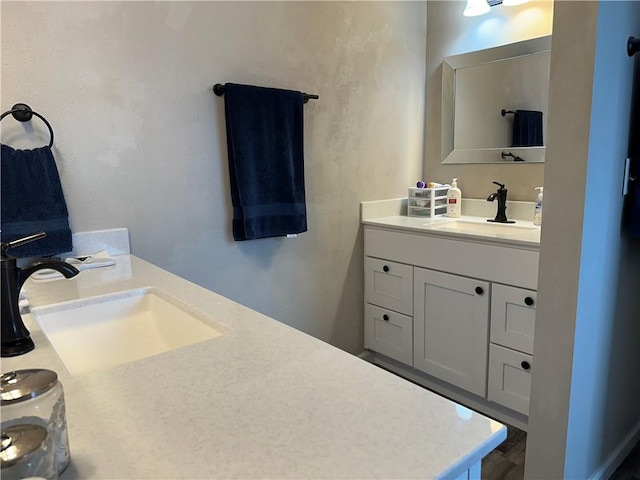 bathroom featuring two vanities and a sink