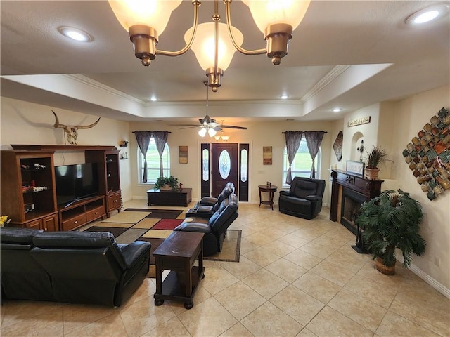 living area featuring light tile patterned floors, baseboards, a raised ceiling, and crown molding