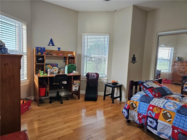 21854 S Floyd Moore Rd, Gentry, AR 72734 - bedroom with multiple windows, wood finished floors, an office area, and baseboards