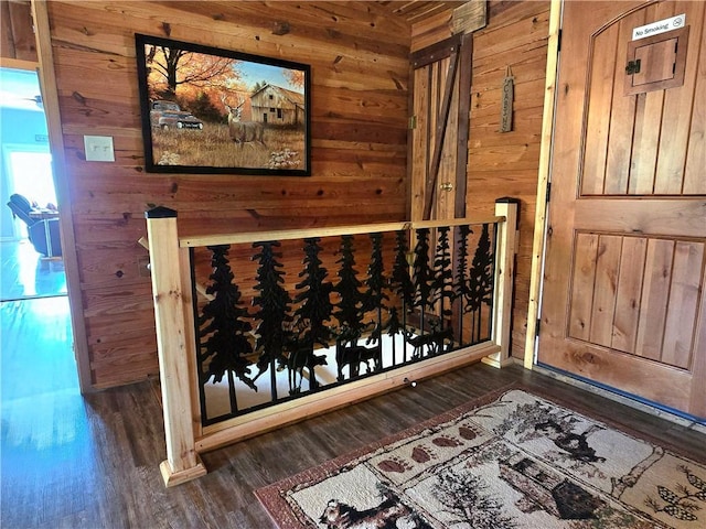 wine area with wooden walls and wood finished floors