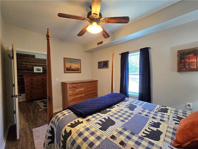 bedroom featuring visible vents, a ceiling fan, and wood finished floors