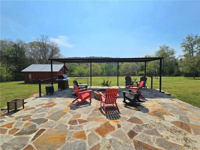 view of patio featuring a gazebo, an outbuilding, a carport, and a grill