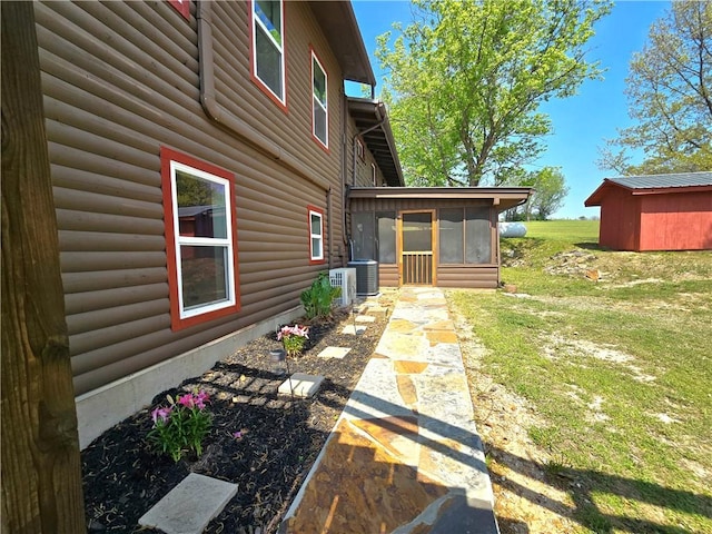 back of house featuring a lawn, a sunroom, faux log siding, and cooling unit