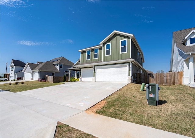 traditional-style house with board and batten siding, an attached garage, driveway, and a residential view