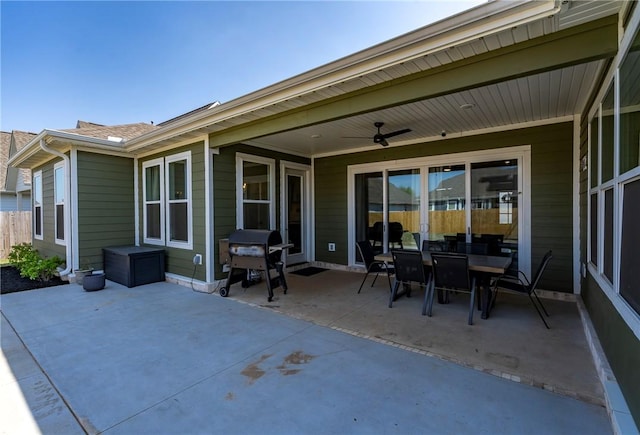 view of patio / terrace featuring grilling area, a ceiling fan, outdoor dining area, and fence