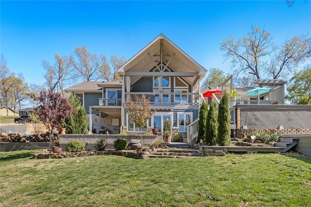back of property featuring a lawn and stairs