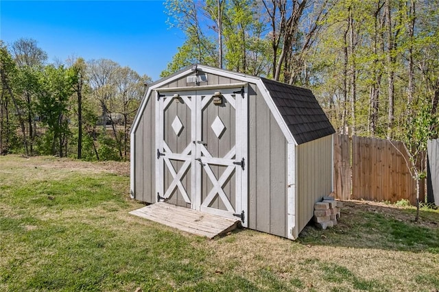 view of shed featuring fence