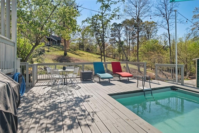 outdoor pool featuring a deck and outdoor dining space