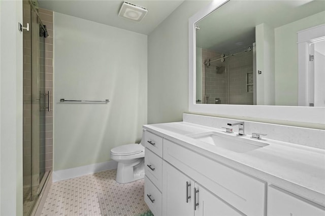 full bath with tile patterned floors, toilet, baseboards, a shower stall, and vanity