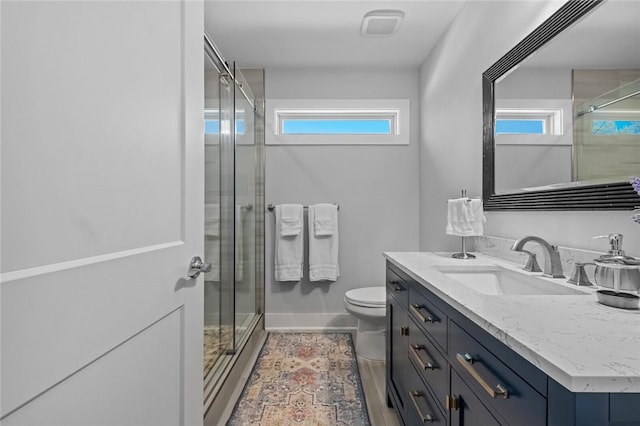 full bathroom with vanity, a wealth of natural light, and a stall shower