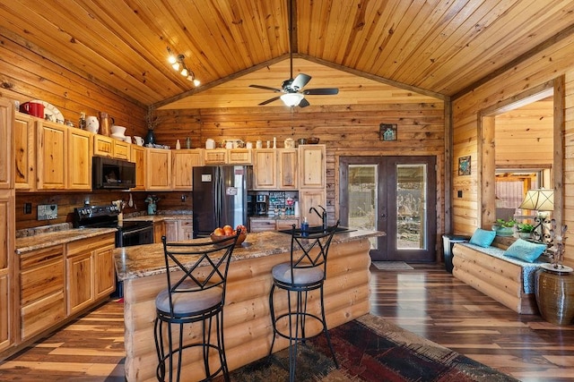 kitchen featuring vaulted ceiling, wooden ceiling, french doors, black appliances, and a breakfast bar area