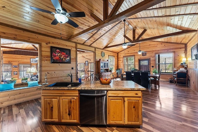 kitchen featuring ceiling fan, open floor plan, and a sink