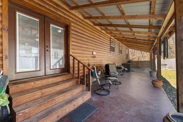 view of patio with central AC, fence, and french doors