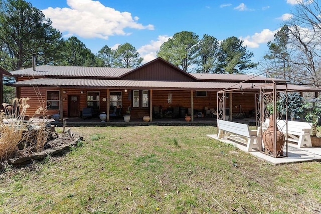back of house with a yard and metal roof
