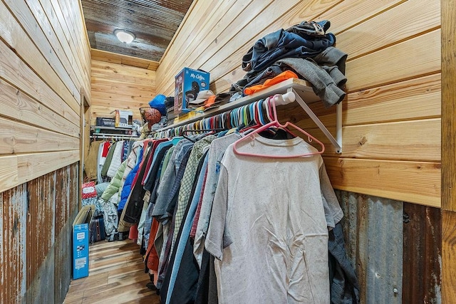 walk in closet with wood finished floors