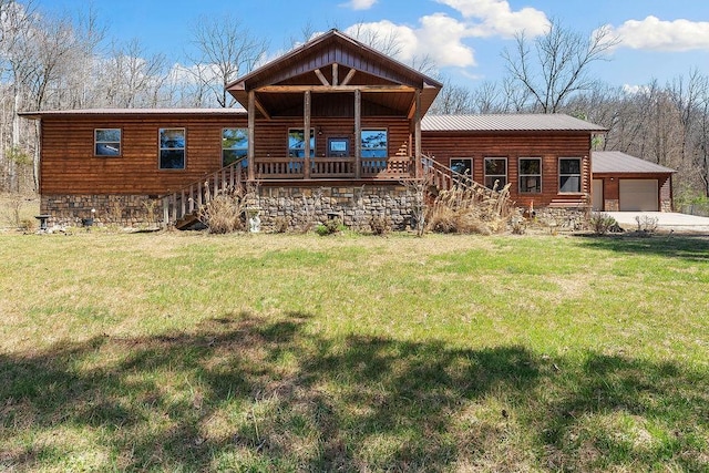 view of front of property featuring a front lawn, stairs, and metal roof