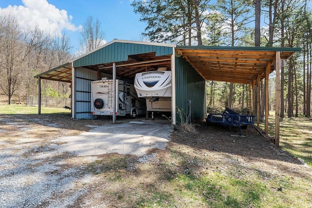 view of vehicle parking featuring dirt driveway and fence