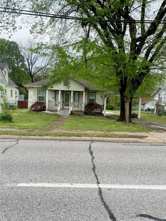 bungalow with a porch and a front yard