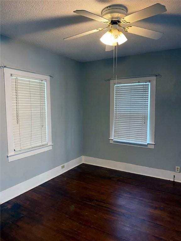 unfurnished room with wood finished floors, a textured ceiling, baseboards, and ceiling fan