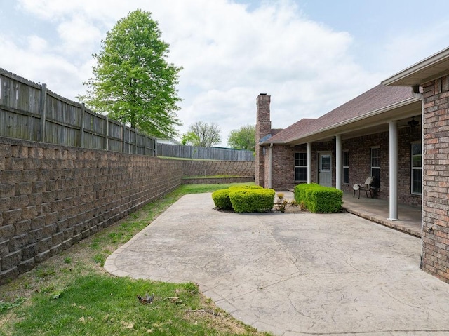 view of yard with a fenced backyard and a patio