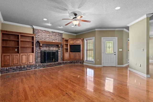 unfurnished living room with light wood-type flooring, baseboards, a textured ceiling, and ceiling fan
