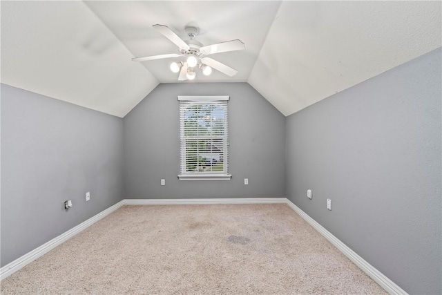 bonus room with ceiling fan, vaulted ceiling, carpet flooring, and baseboards