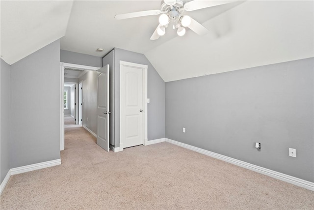 bonus room with baseboards, vaulted ceiling, a ceiling fan, and carpet