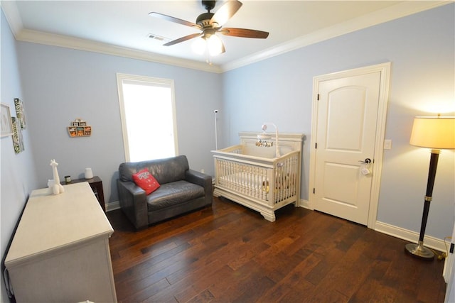 bedroom featuring baseboards, visible vents, dark wood-style floors, and ornamental molding