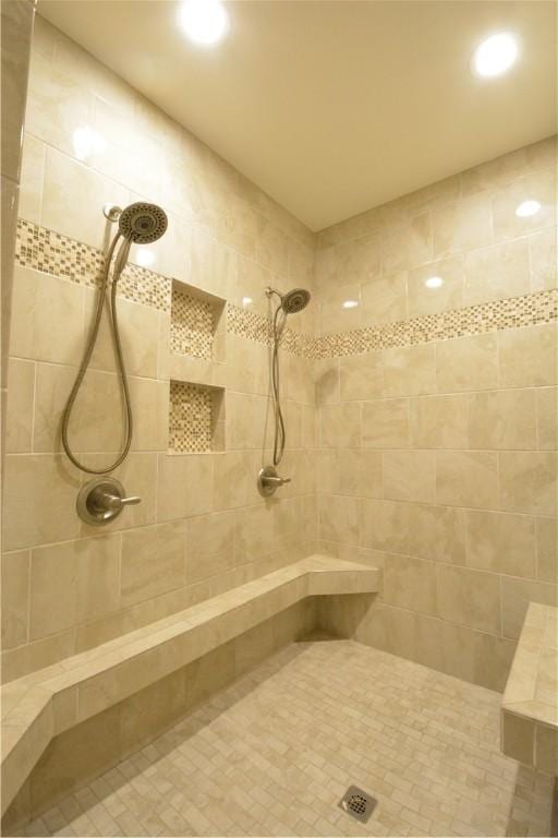 full bathroom featuring recessed lighting and tiled shower