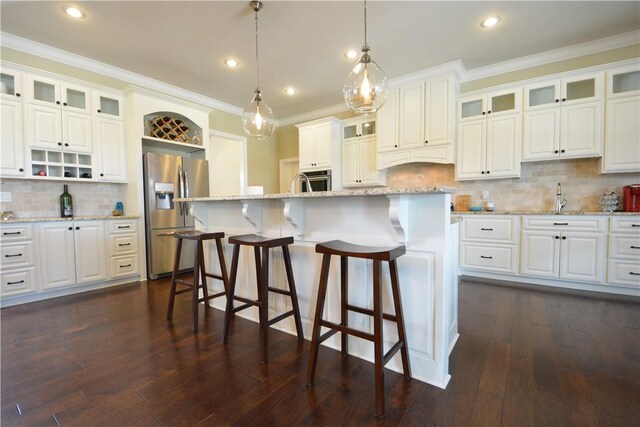 kitchen with a kitchen breakfast bar, crown molding, open shelves, tasteful backsplash, and stainless steel appliances