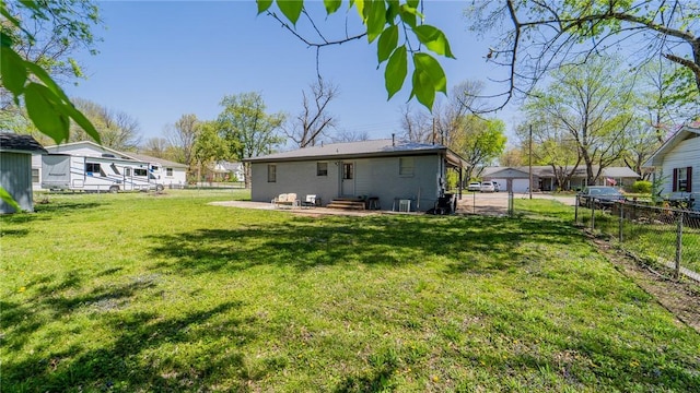 rear view of house with a patio, a fenced backyard, a yard, and entry steps