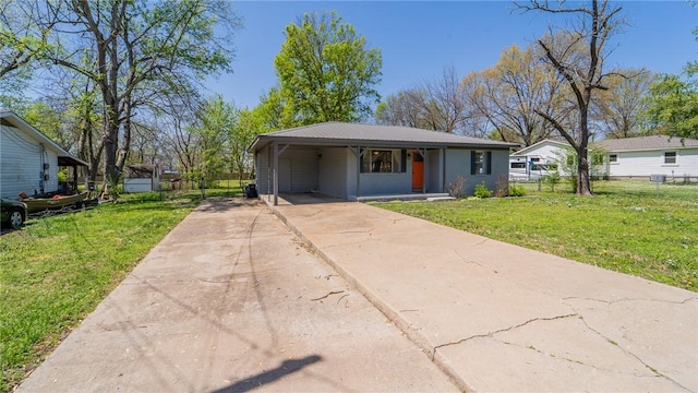 bungalow-style home featuring concrete driveway, fence, metal roof, and a front yard