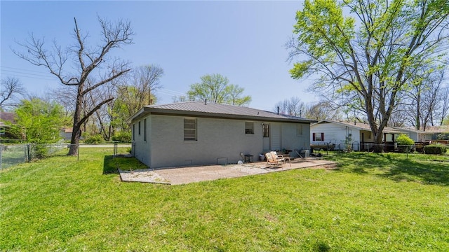 rear view of property featuring crawl space, a fenced backyard, a patio area, a yard, and metal roof