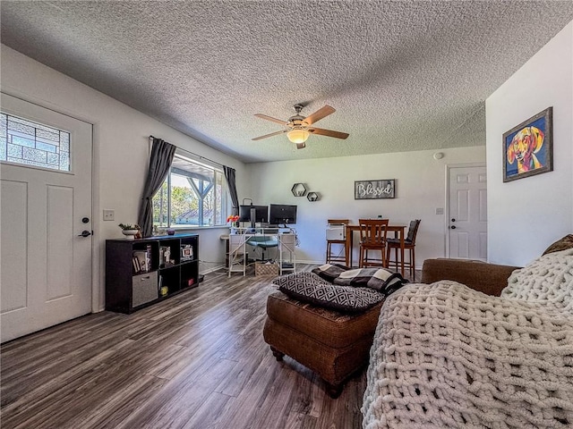 living room featuring a textured ceiling, a ceiling fan, and wood finished floors