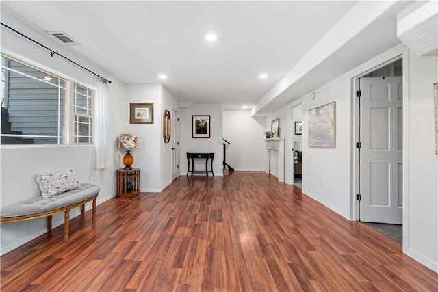 sitting room featuring baseboards, wood finished floors, and recessed lighting