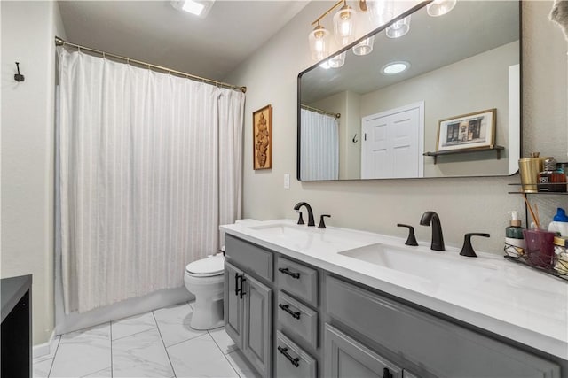 full bathroom with marble finish floor, toilet, a sink, and double vanity