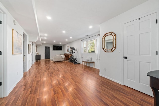 living room featuring recessed lighting, wood finished floors, and baseboards