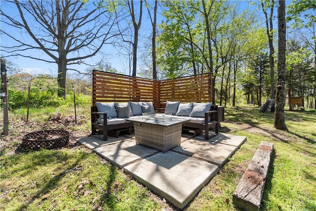view of patio featuring an outdoor living space with a fire pit