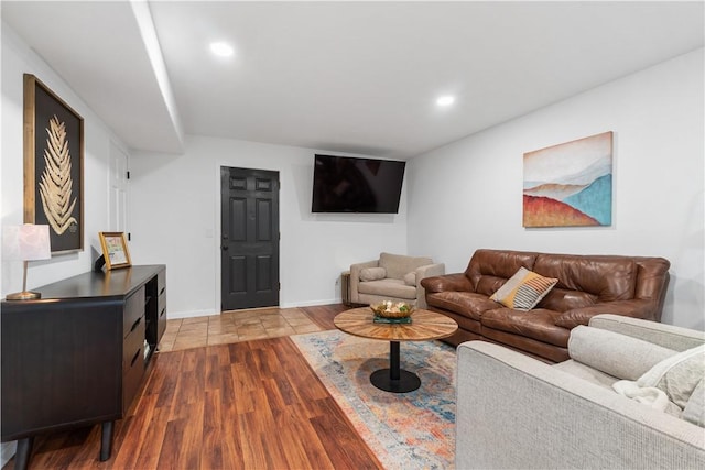 living area featuring baseboards, wood finished floors, and recessed lighting