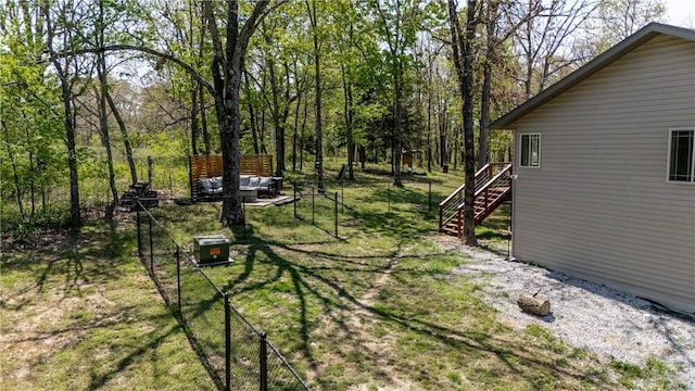 view of yard with fence and stairs