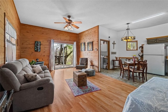2080 E Van Buren, Eureka Springs, AR 72632 - living room with ceiling fan, wood walls, wood finished floors, and a textured ceiling