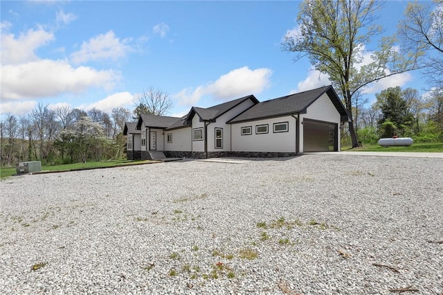 ranch-style house with a garage and driveway