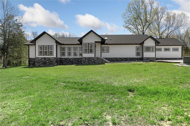 single story home with a front lawn and stone siding