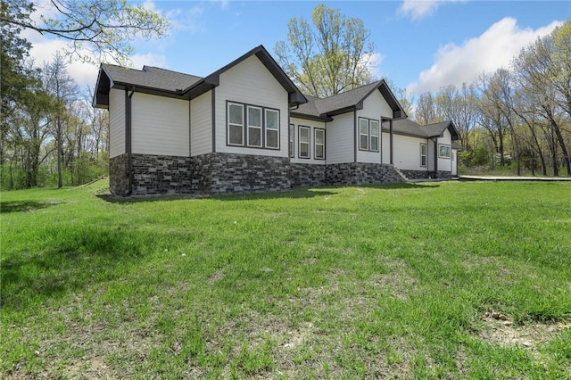 rear view of property with a yard